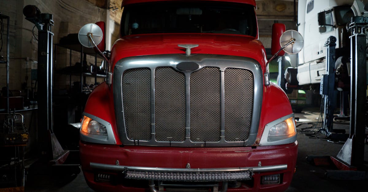 Front view of a truck in a low-lit industrial garage.