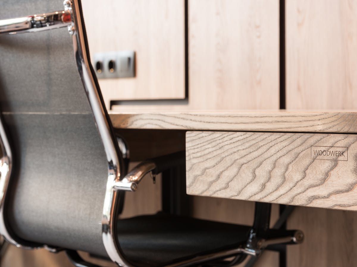 Wooden desk in a quiet, modern office.